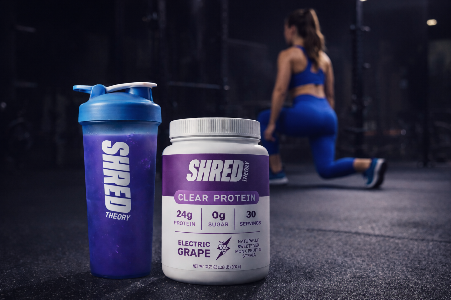Shred Theory Clear Protein tub and shaker bottle with protein liquid and woman working out in the background